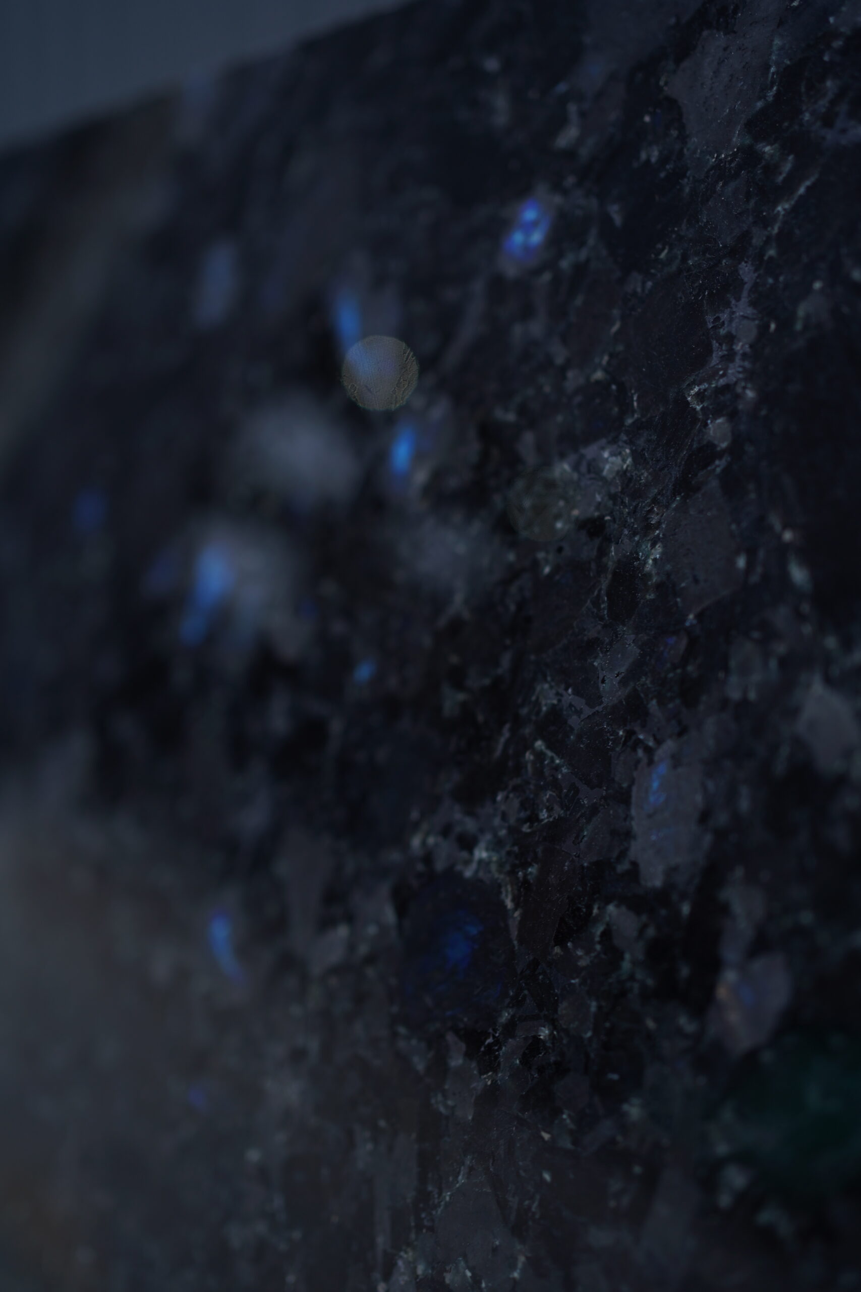 Natural Volga Blue labradorite texture with deep graphite base and subtle blue iridescence