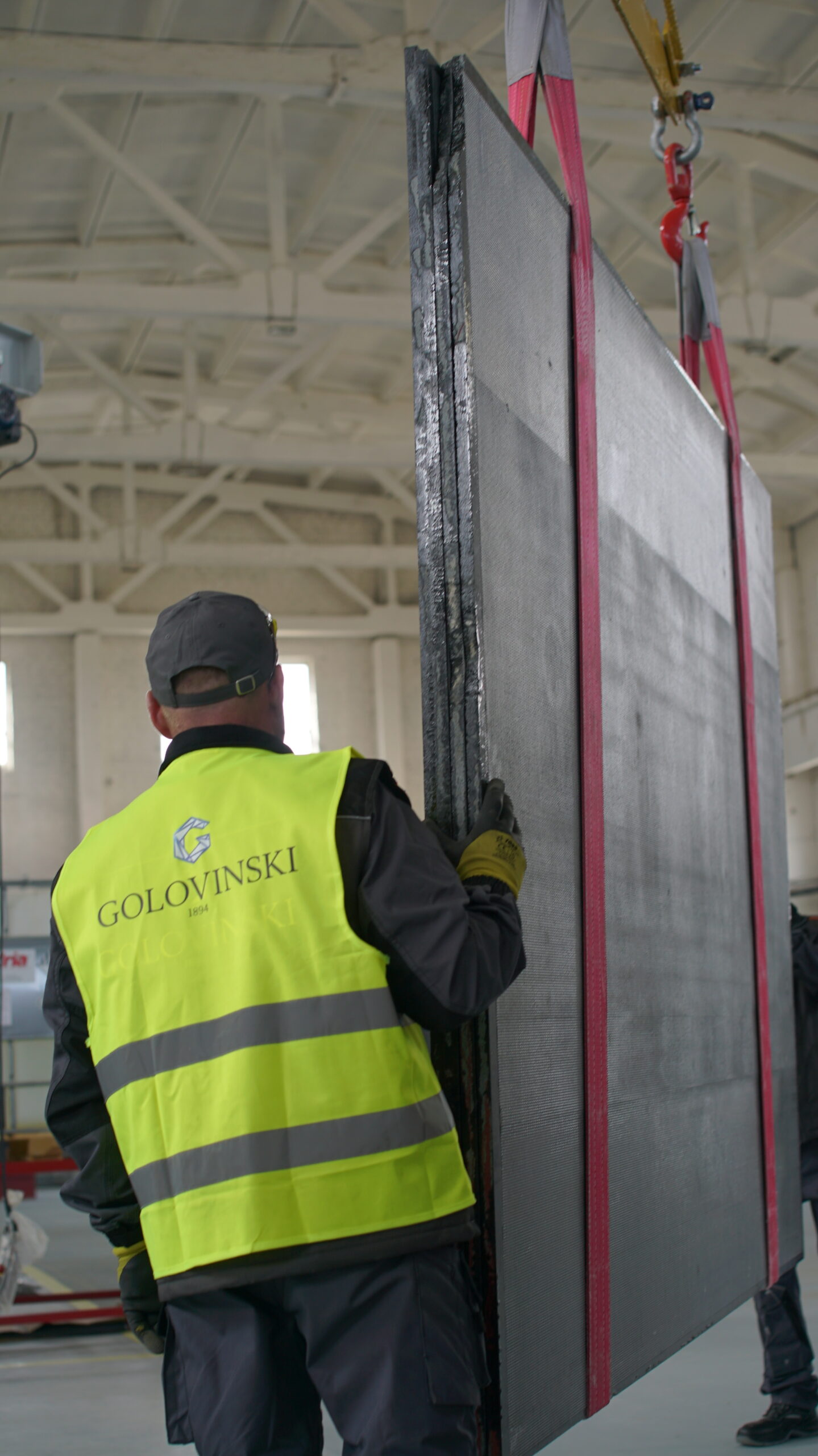 Handling and inspection of large-format Volga Blue labradorite slab at Golovinski production facility