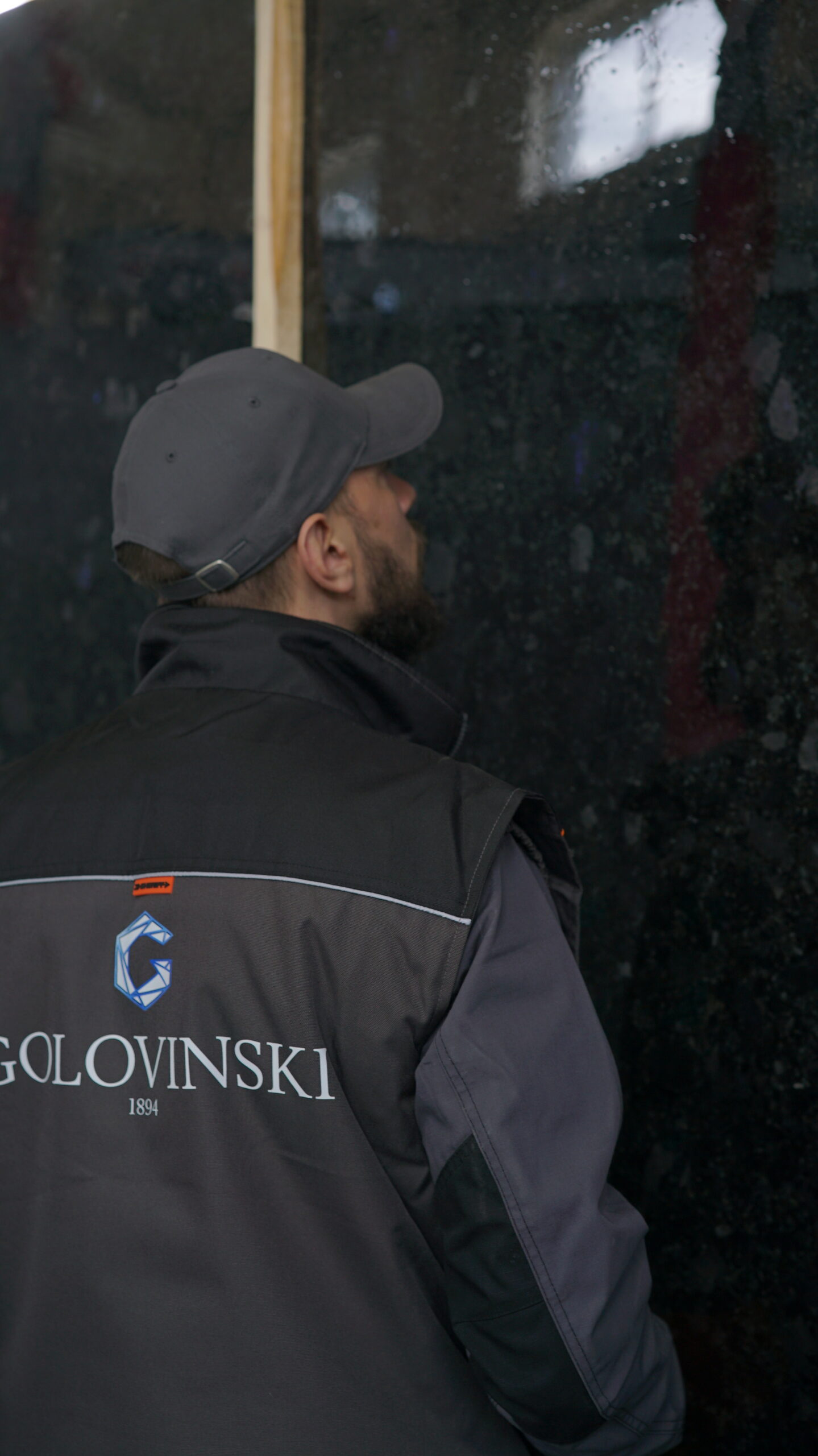 Golovinski specialist inspecting Volga Blue labradorite slab at production facility