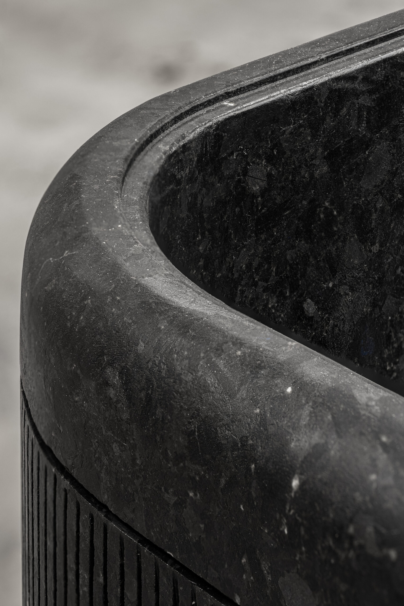 Close-up of the edge of a monolithic labradorite bathtub