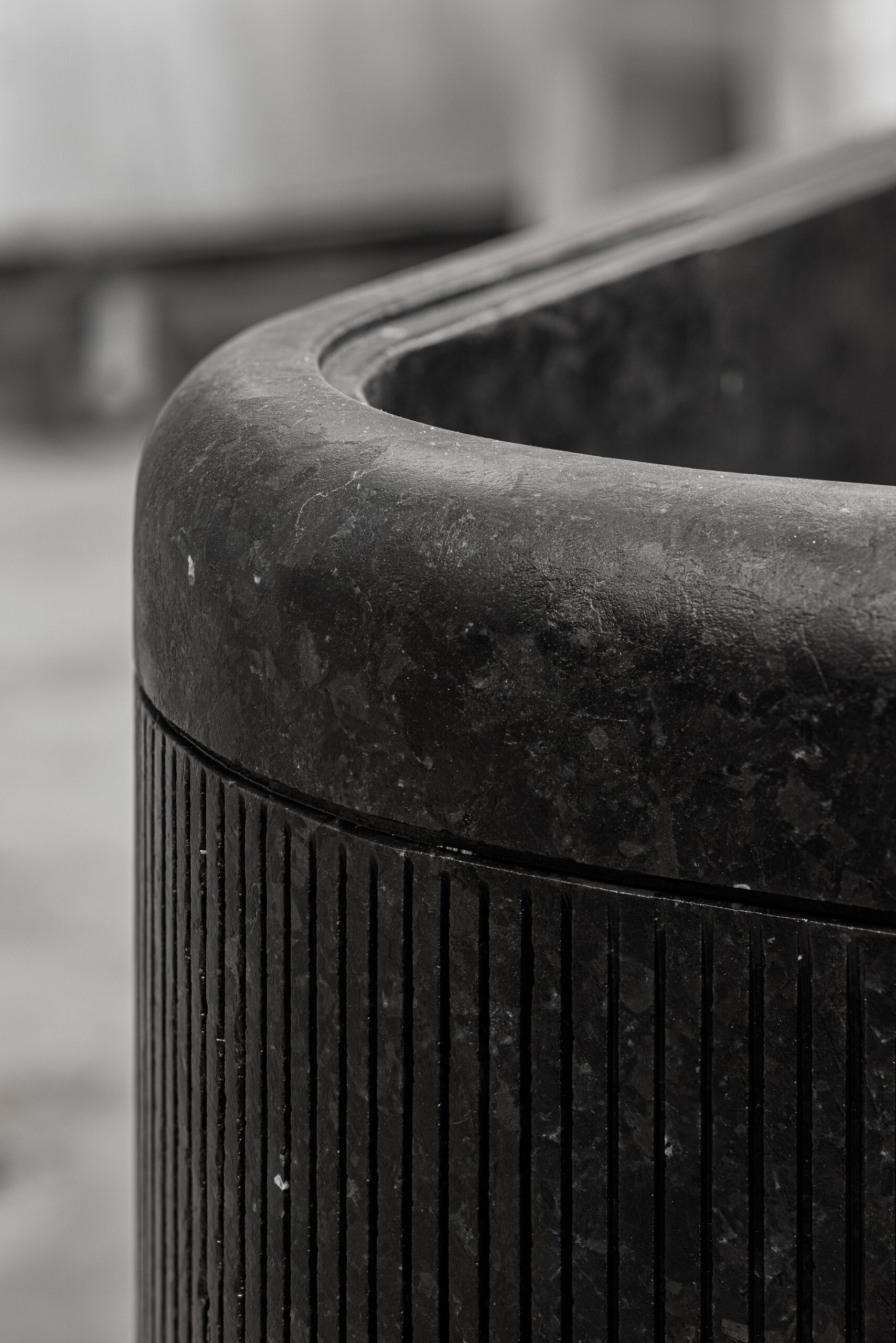 Rounded edge of a monolithic labradorite bathtub close-up