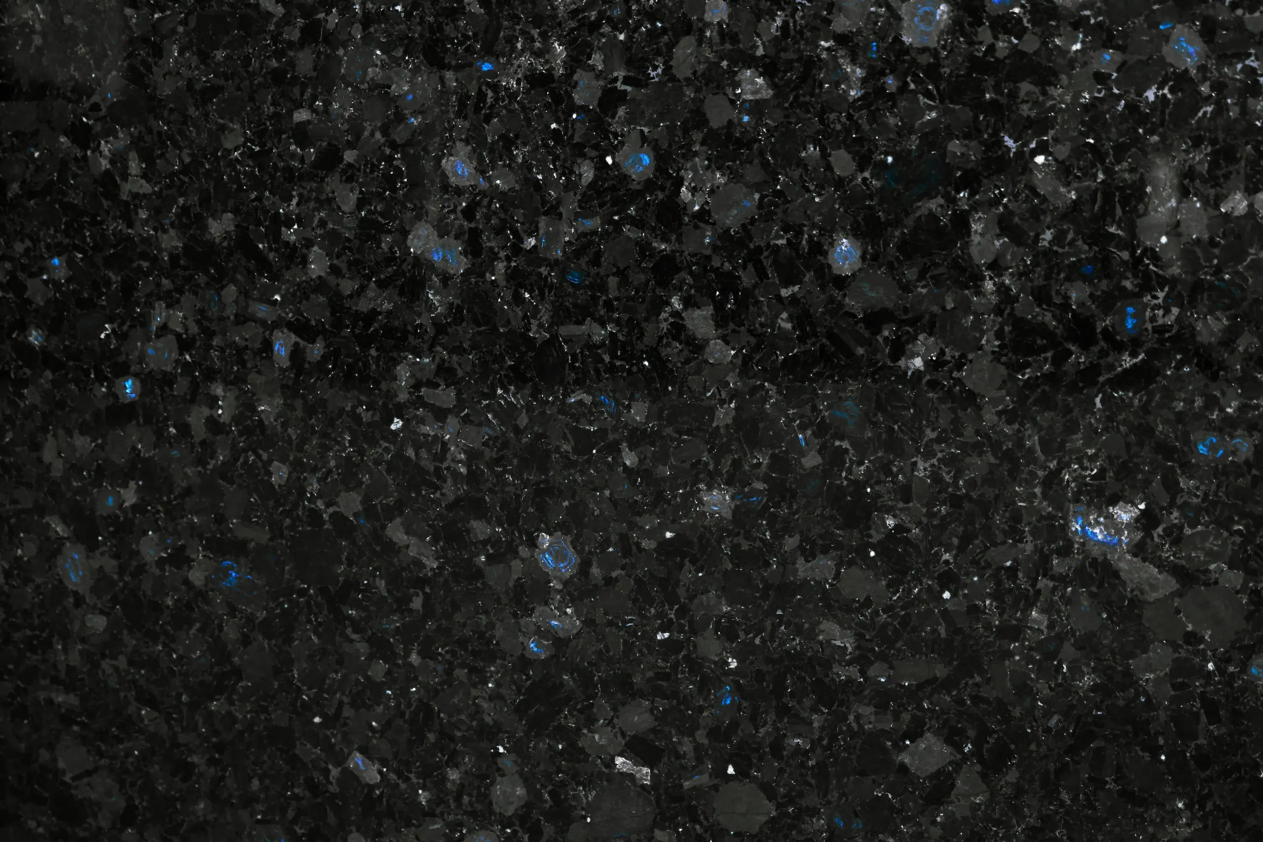 Black stone facade with labradorite in winter conditions with lighting